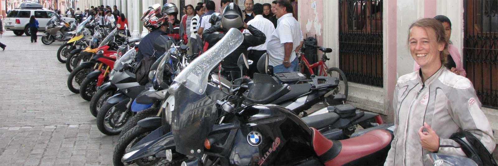 Motorcycles lined up along the street