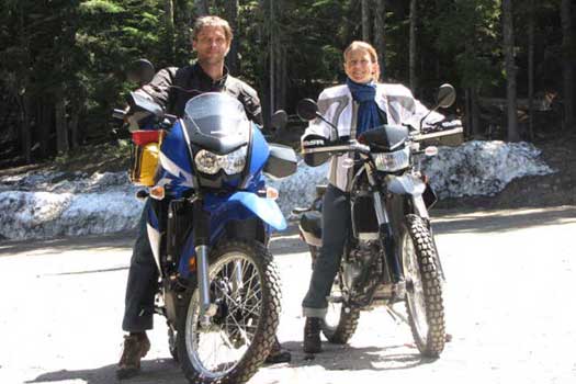 Two people sitting on motorcycles