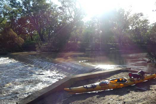 Kayak beside a weir