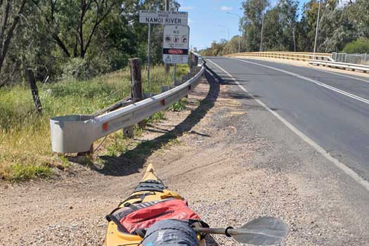 Kayak beside a bridge