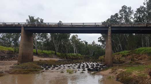 Weir with water spilling over it