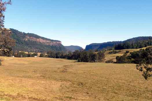 Farmland with rocky river gorge in the distance