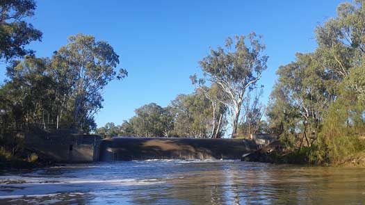 Weir with water spilling over it