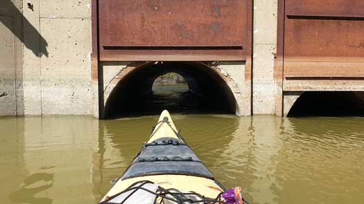 Kayak facing a small pipe