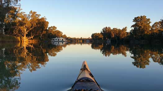 Wide still river with houseboats