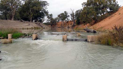 Broken weir on river