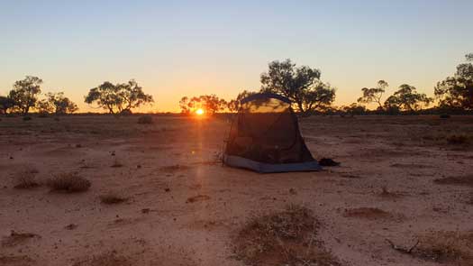 Red clay sand plains with tent