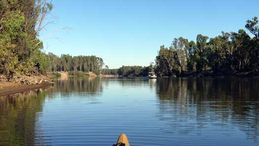 Calm river with a fishing boat