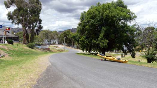 kayak on road with lake in distance