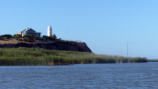 House and lighthouse on the shore