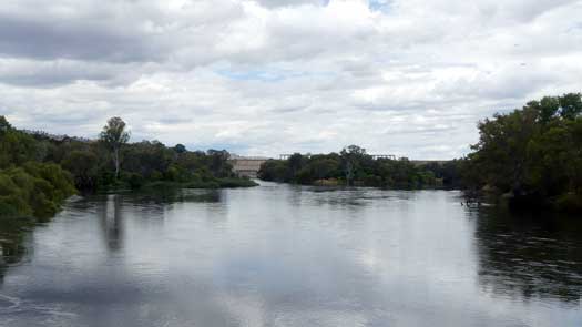 Large river with a dam in the background