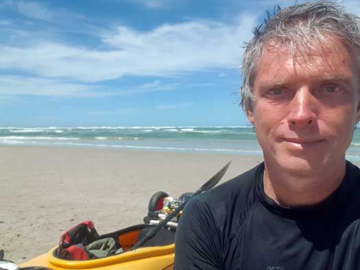 Person on a beach with the ocean in the background