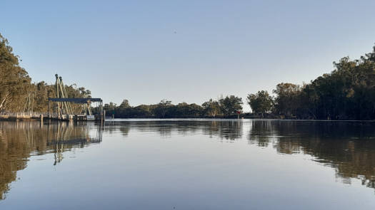 River in flood and mostly submerged weir