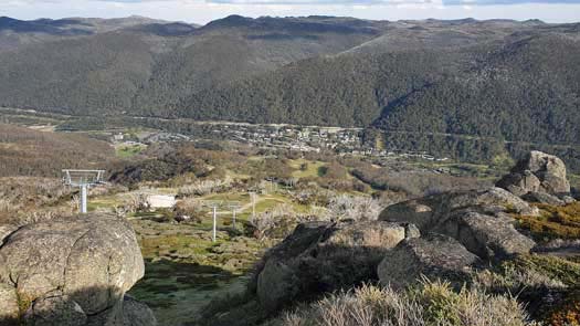 Looking down a large hill to a town at the bottom