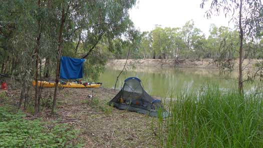 Tent and kayak beside a river