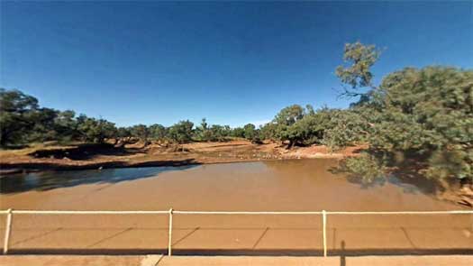 Dirty water behind a small dam