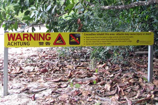 Sign warning about crocodiles in multiple languages